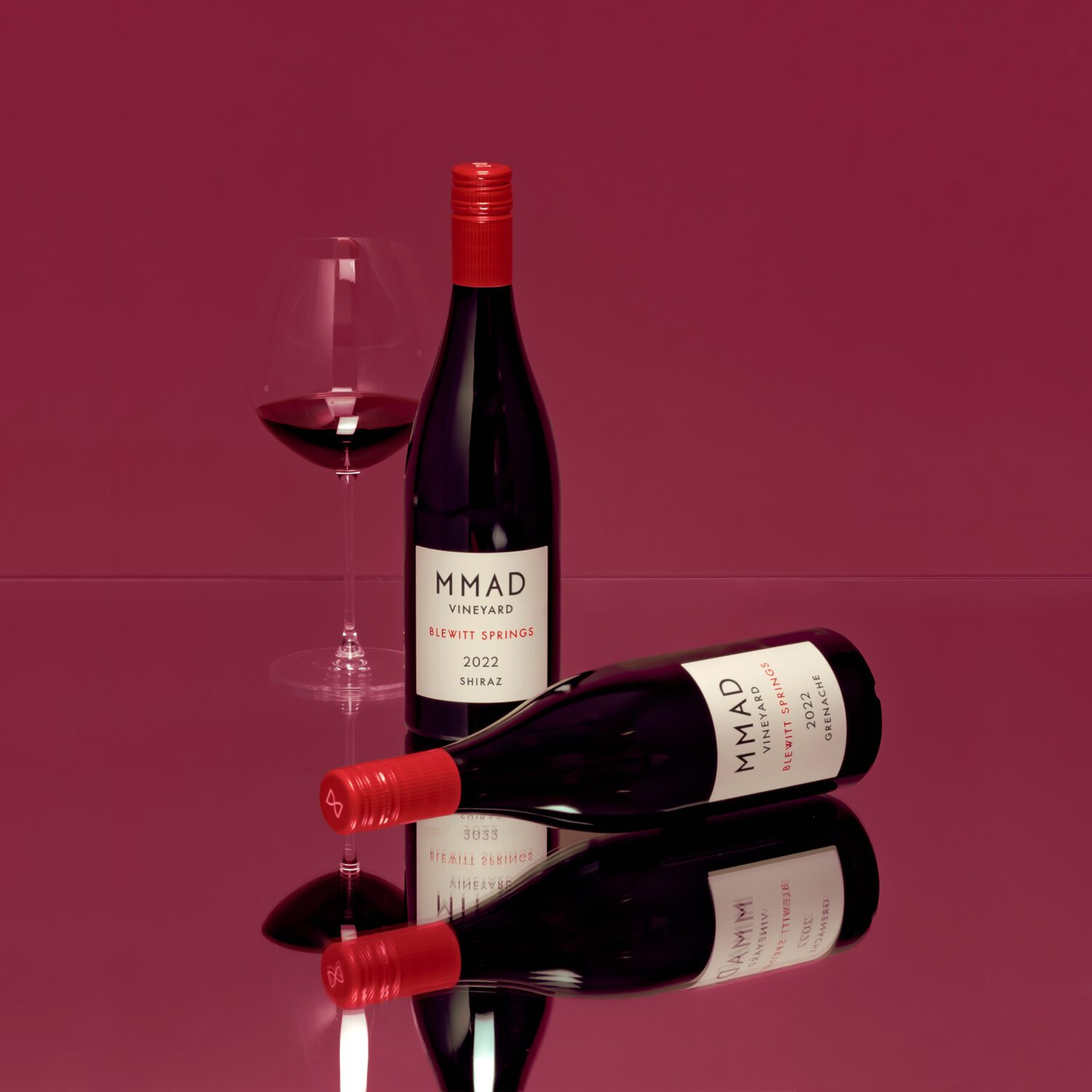 Two bottles and a glass of wine to show the MMAD Autumn Allocation
