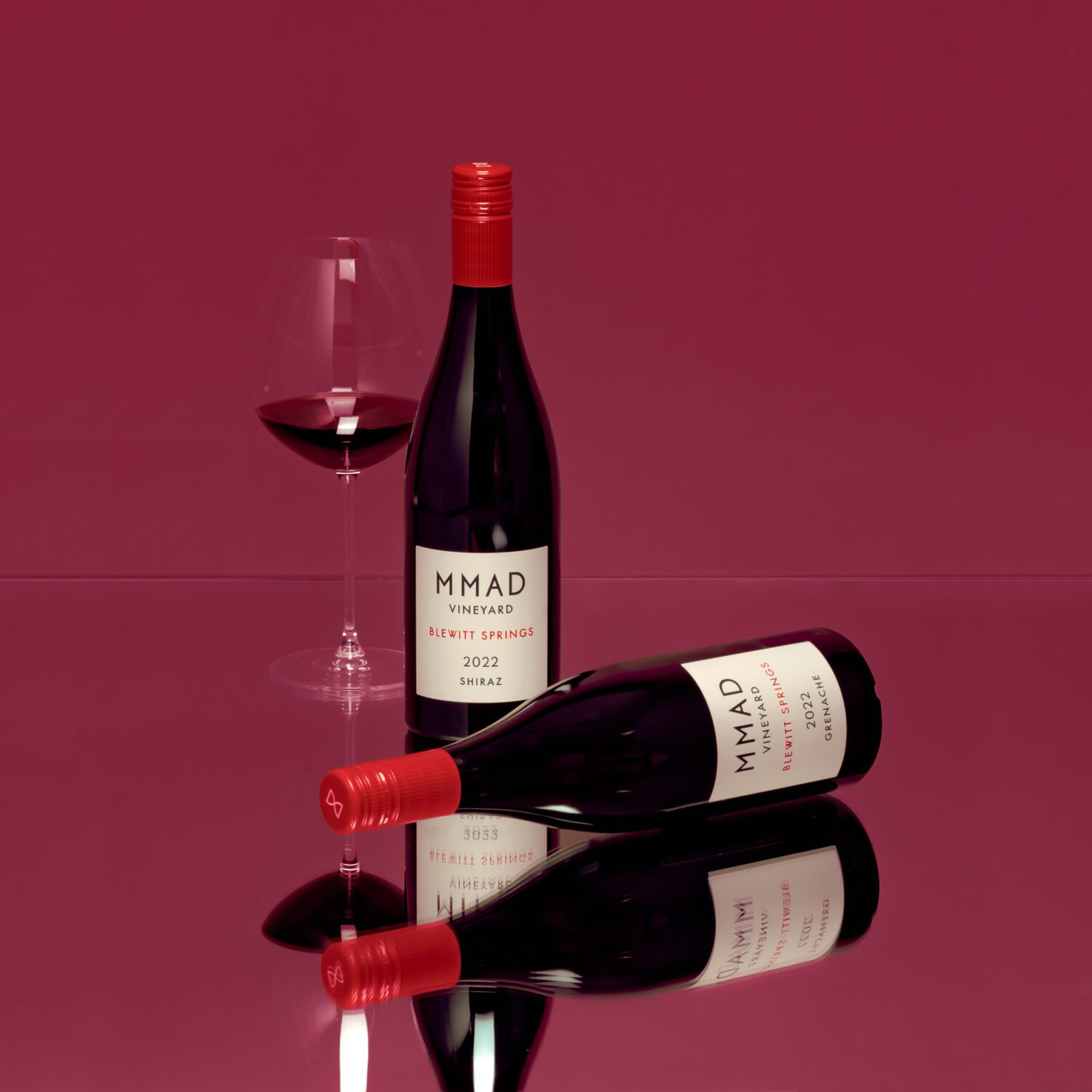 MMAD Vineyard Autumn Allocation Two bottles and a glass of wine to show the MMAD Autumn Allocation